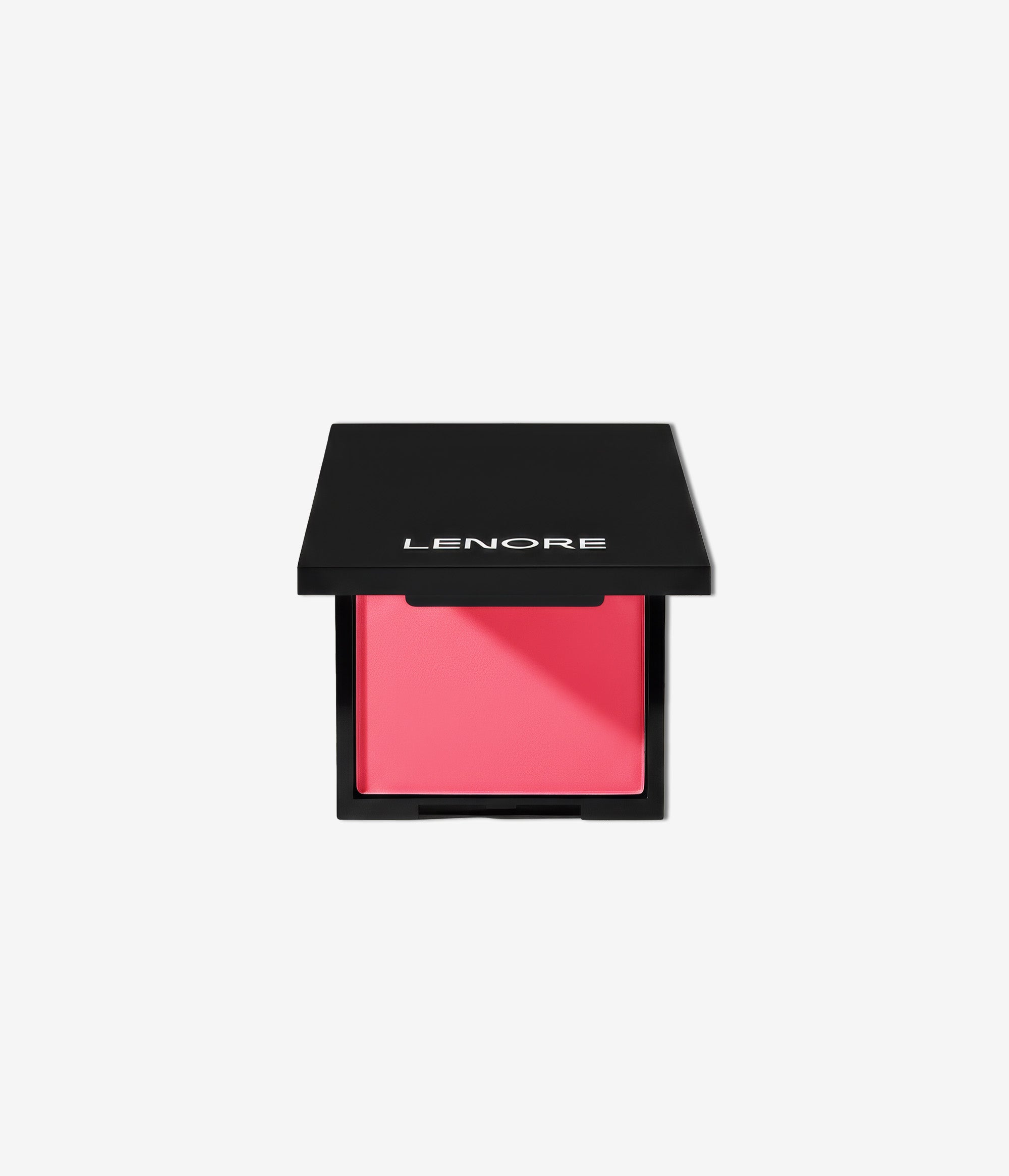 Pink makeup compact with black lid on a light gray background