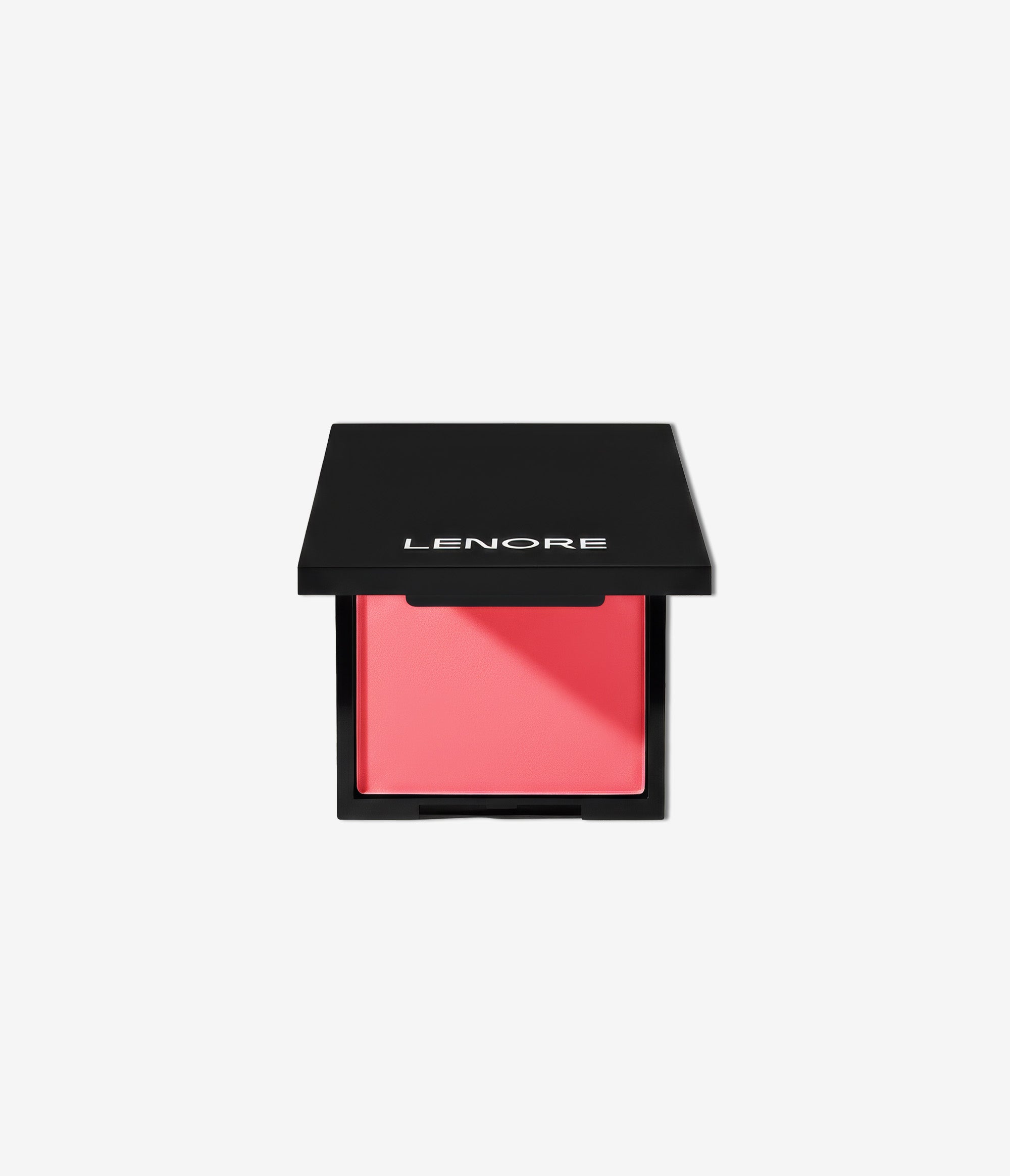Pink blush compact with black lid on a light gray background